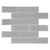 Gray glass subway tiles showcasing a mix of smooth and textured surfaces, designed to add subtle depth to interior spaces.